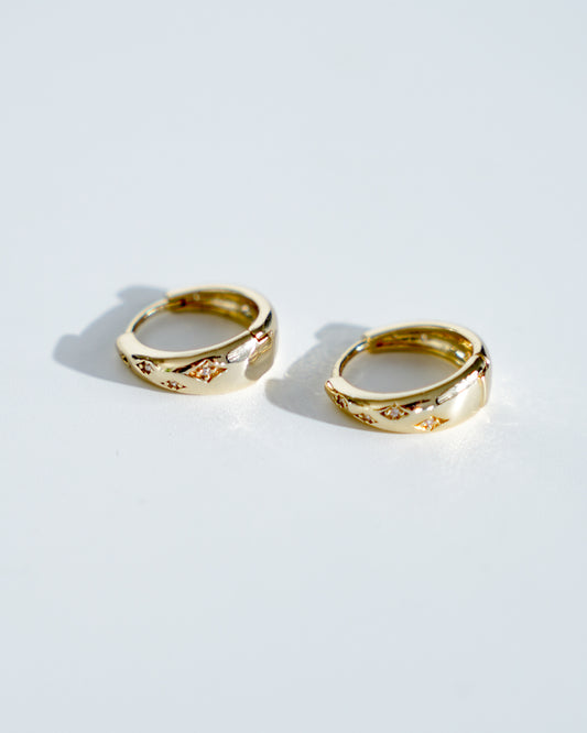 18k gold plated oval shaped cubic zirconia featured huggies