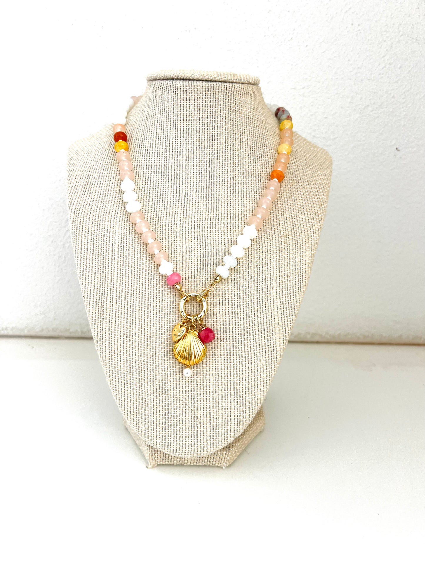 Pink toned gemstone necklace with shell