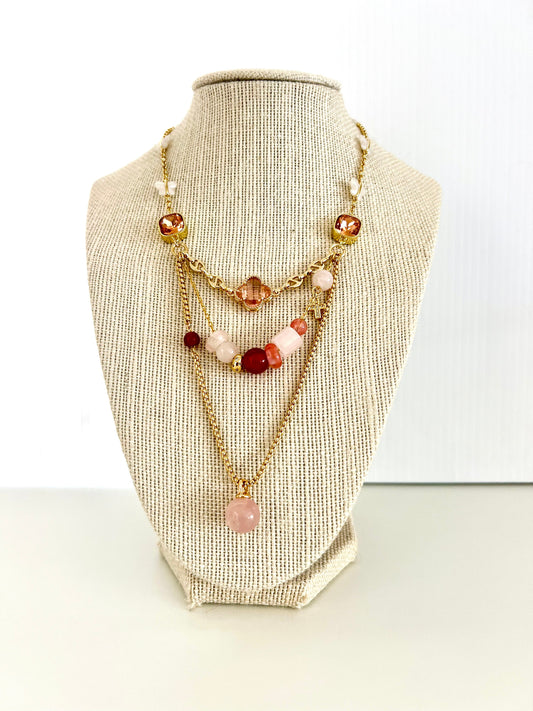 Gold-plated layered necklace with green crystal connectors, amber clover, cubic zirconia cross and aventurine ball charm