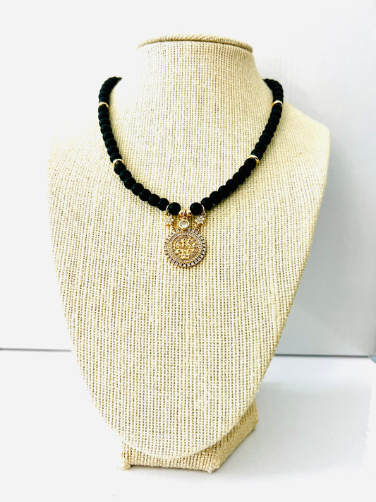 Black onyx beaded necklace with faceted beads and a cubic zirconia pavé coin pendant
