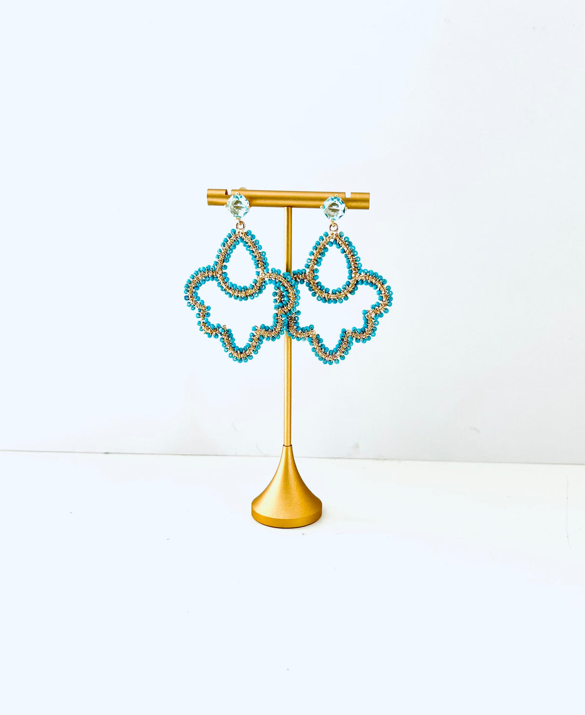 Turquoise beaded drop earrings with pale blue cubic zirconia posts in an open silhouette