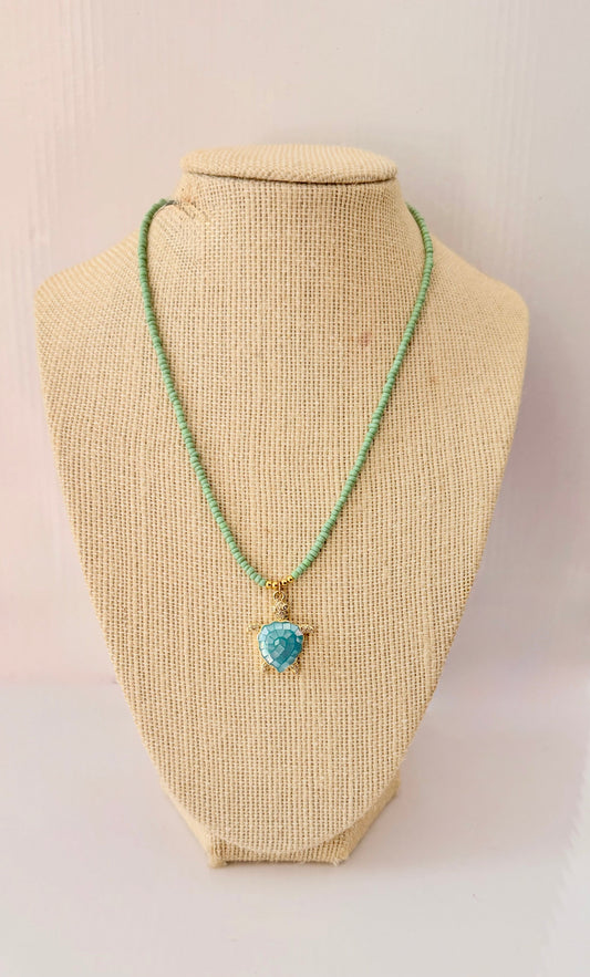 Green beaded necklace with an 18k gold plated blue mosaic turtle charm